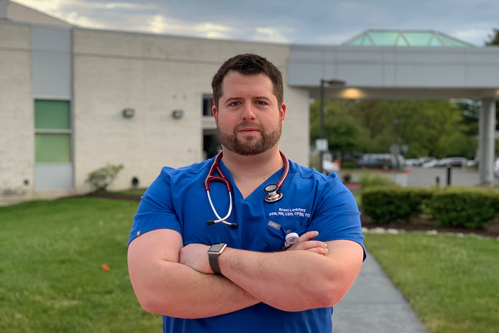 UVA Nursing grad Brent Lankford (BSN `10) standing outside Calvert Health Medical Center in southern Maryland where he works as an Emergency Department charge nurse