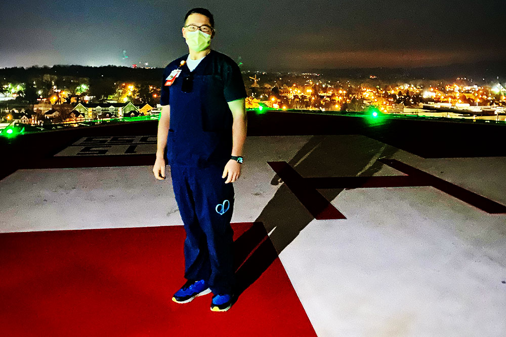 RN to BSN graduate Chase Smith, an ER and travel nurse, standing on the MUSC helipad.