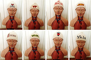 Professor Christine Connelly's anatomy models wearing different university caps, part of a game she played with her first year nursing anatomy lab students.