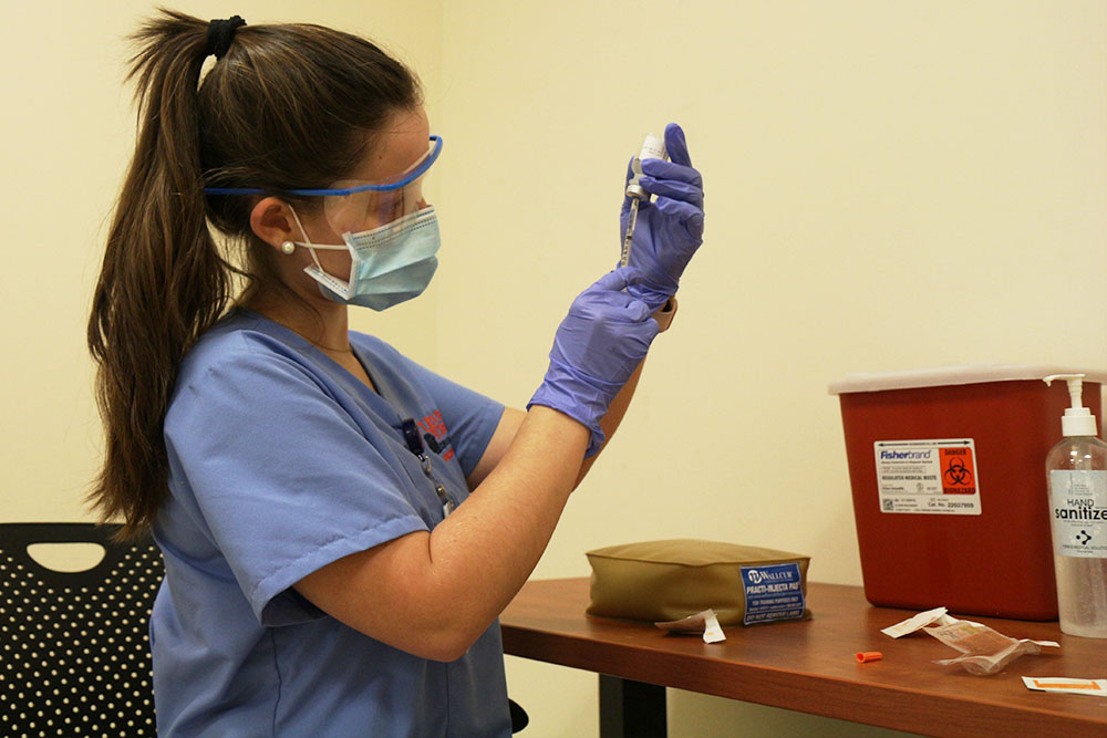 BSN student Madison McMahon practices vaccinating at a simulation.
