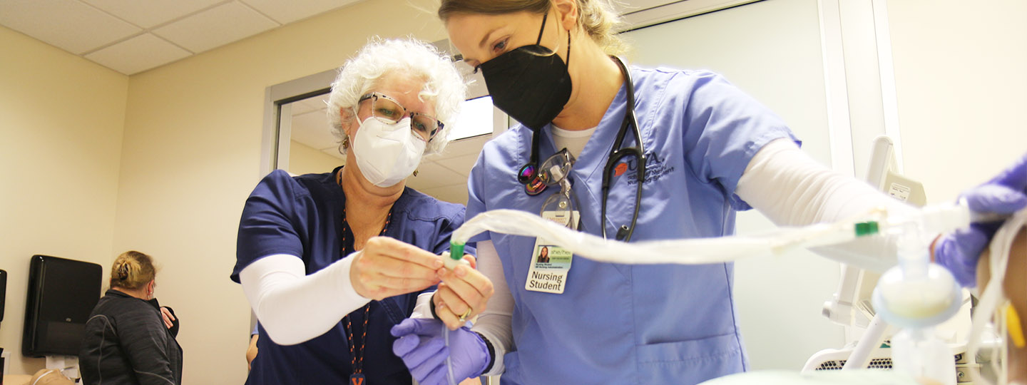 An image of a CNL student learning intubation processes from prof. Beth Hundt.