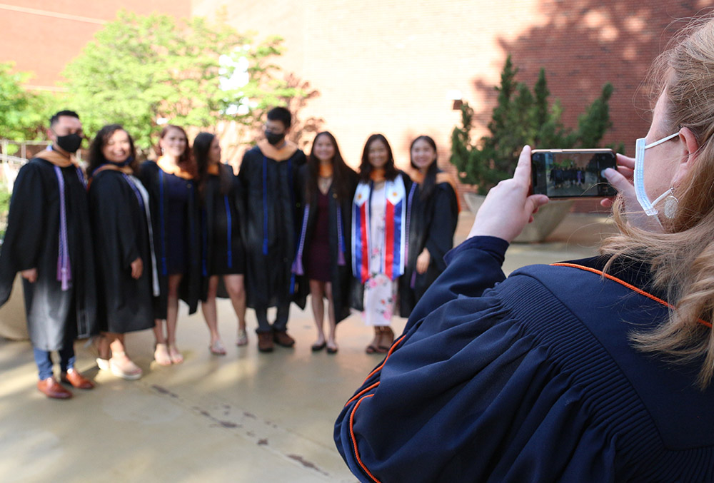 Professor Sarah Craig takes a picture of CNL graduates in 2021.