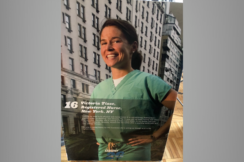 Smiling dark haired woman standing outside with a stethoscope