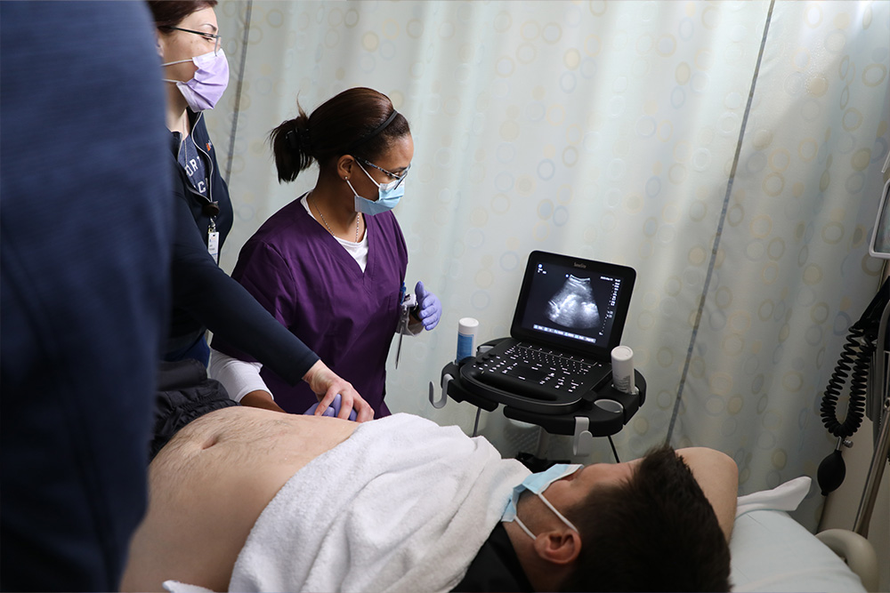 APRN students in the sim lab work to refine their ultrasound skills.