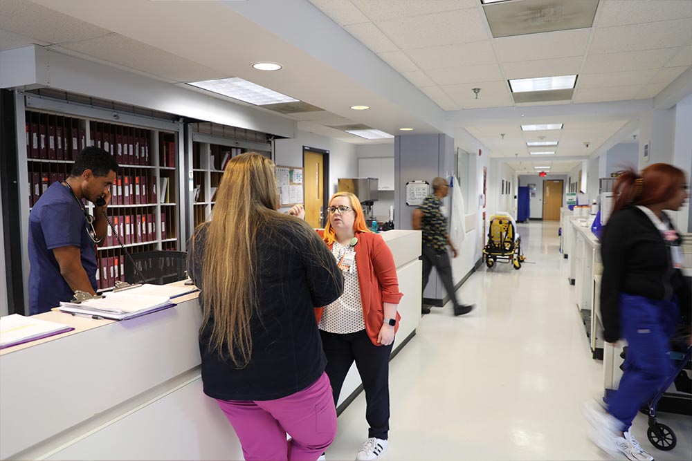 CNL grad Emily Brady in a busy UVA Health dialysis clinic