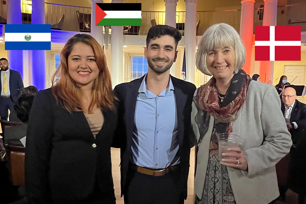 Katherine Flores, a Walentas Scholar from El Salvador, Abdallah Aljerjawi, from Gaza, and Dean Marianne Baernholdt, from Denmark pose at Pres. Ryan's annual Double Take storytelling event in February 2023.
