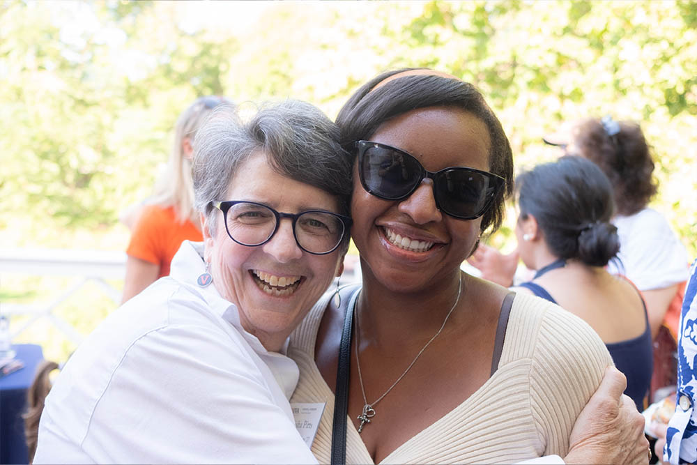 two women smiling and hugging