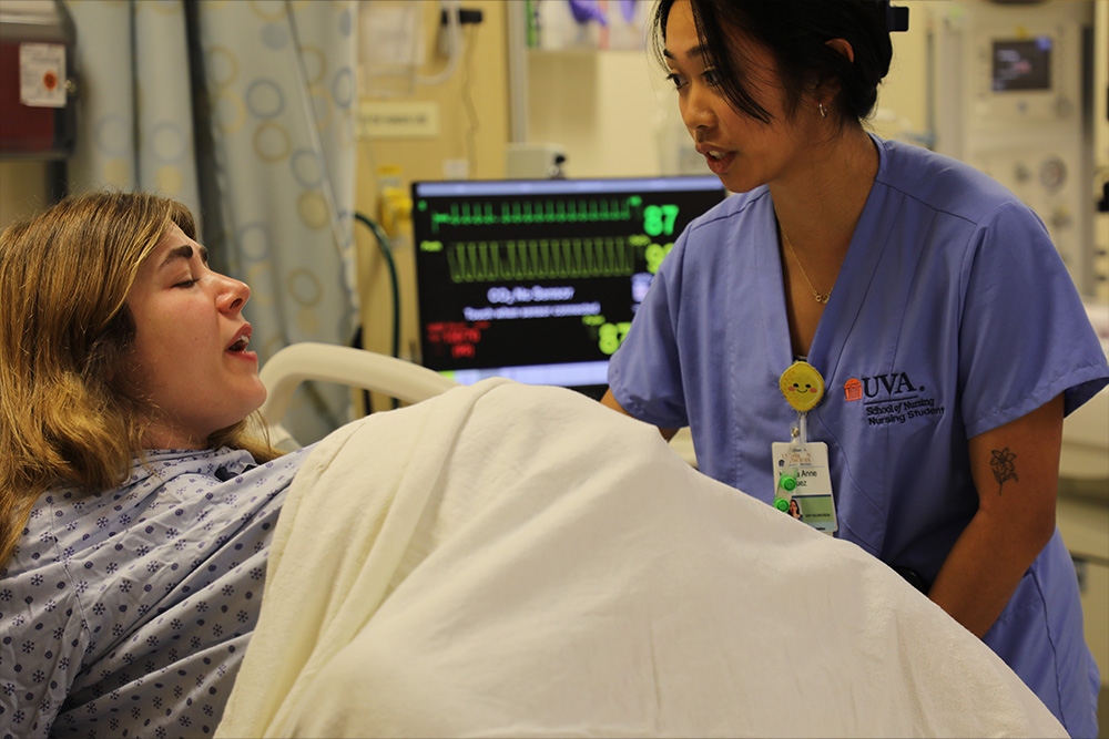 Birthing simulation - the patient experiences contractions while a student tends her
